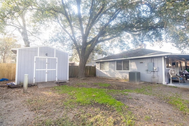 exterior space featuring central air condition unit and a storage unit