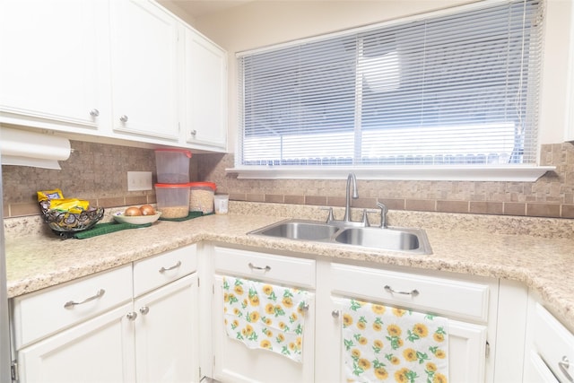 kitchen with sink, decorative backsplash, and white cabinets