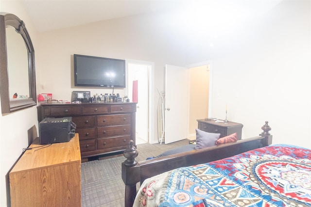 bedroom with lofted ceiling and carpet flooring