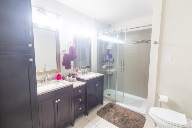 bathroom featuring an enclosed shower, vanity, tile patterned flooring, and toilet