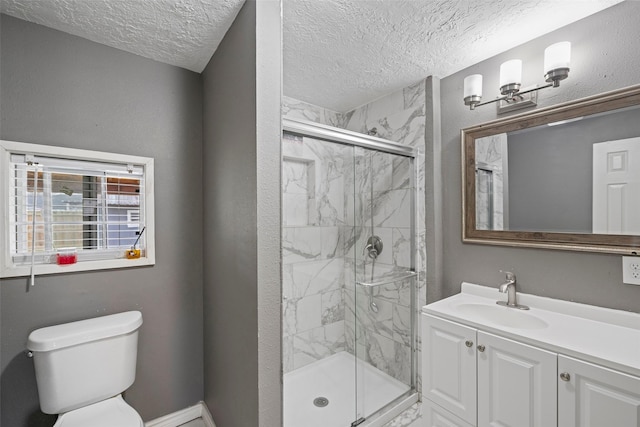 bathroom featuring vanity, toilet, a textured ceiling, and walk in shower