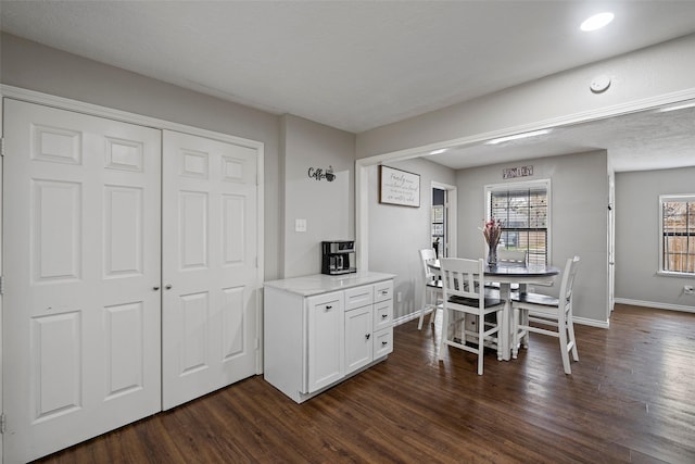 dining space with dark hardwood / wood-style floors