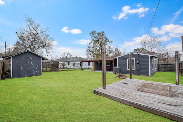 view of yard featuring central AC, a storage shed, and a deck