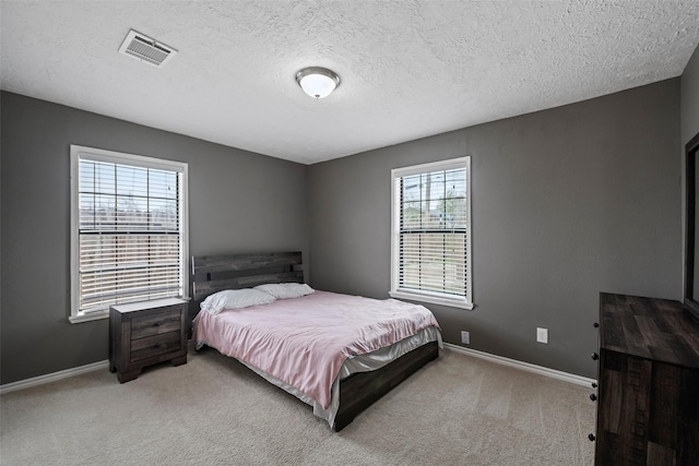 carpeted bedroom featuring a textured ceiling