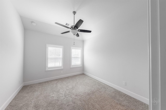 carpeted spare room featuring ceiling fan