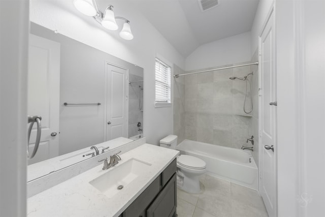 full bathroom featuring lofted ceiling, tiled shower / bath combo, vanity, toilet, and tile patterned floors