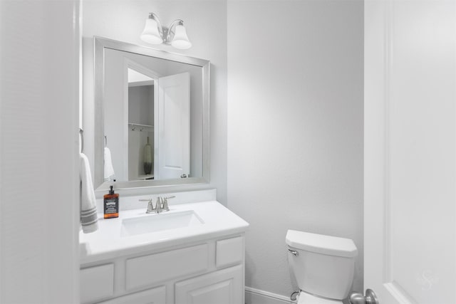 bathroom featuring vanity and toilet