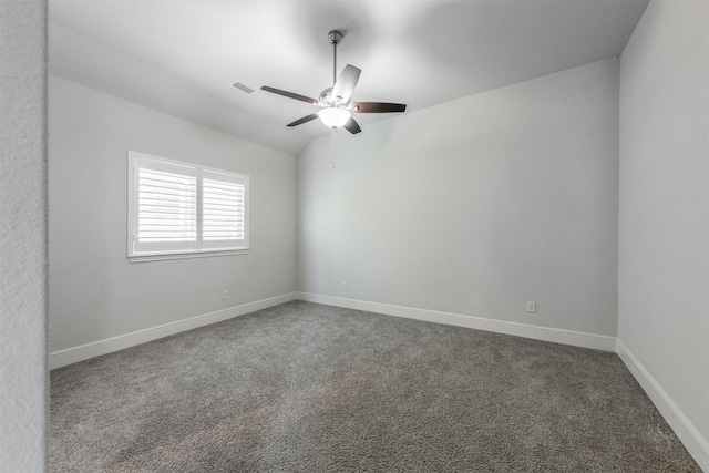 carpeted empty room featuring ceiling fan and vaulted ceiling