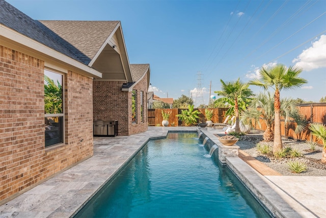 view of swimming pool featuring a patio and pool water feature