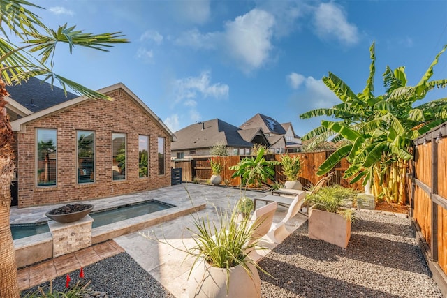 view of patio / terrace featuring an in ground hot tub