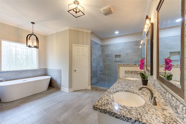 bathroom with ornamental molding, shower with separate bathtub, and vanity