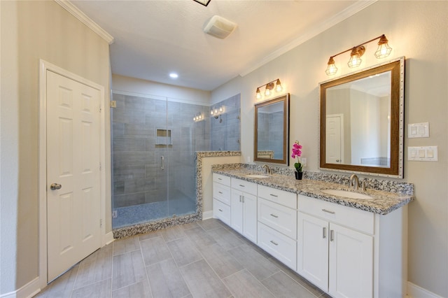 bathroom with crown molding, vanity, and a shower with door