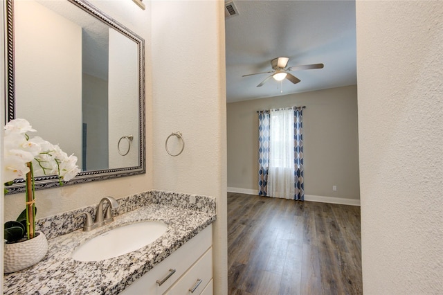 bathroom with vanity, wood-type flooring, and ceiling fan