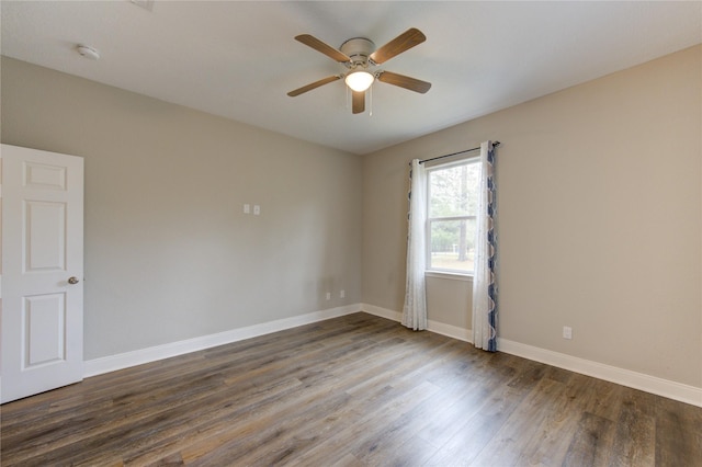 unfurnished room with dark hardwood / wood-style floors and ceiling fan