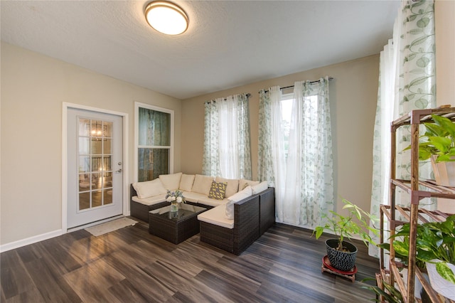 living room with dark hardwood / wood-style floors and a textured ceiling