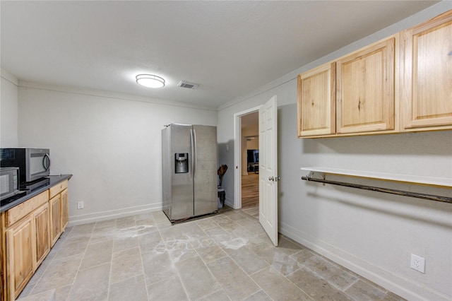 kitchen with appliances with stainless steel finishes and light brown cabinets