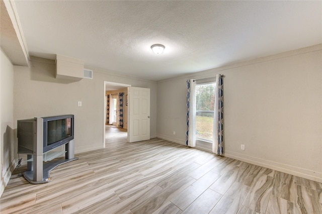 unfurnished living room featuring a textured ceiling and light wood-type flooring