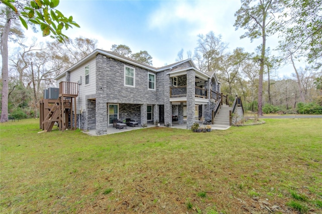 rear view of house with a yard, a patio area, and central AC