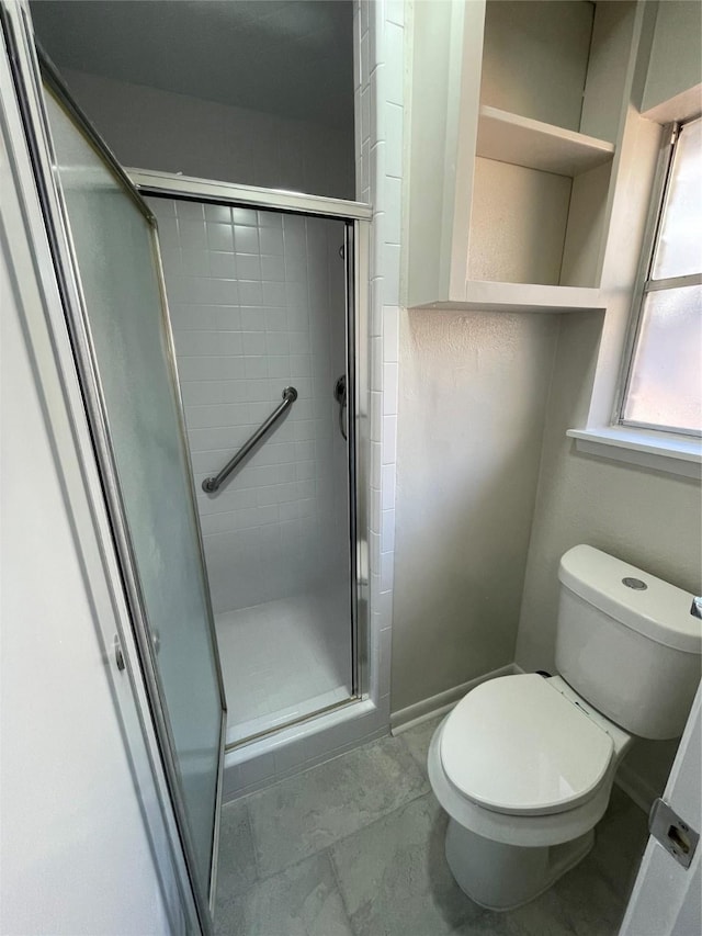 bathroom featuring walk in shower and toilet