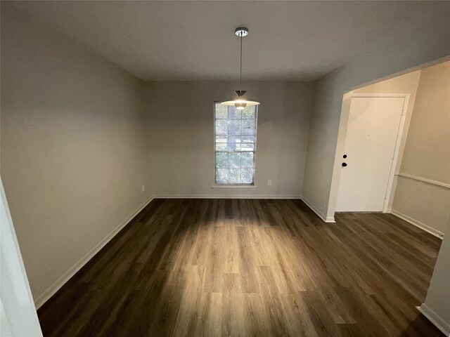 unfurnished dining area featuring dark hardwood / wood-style floors