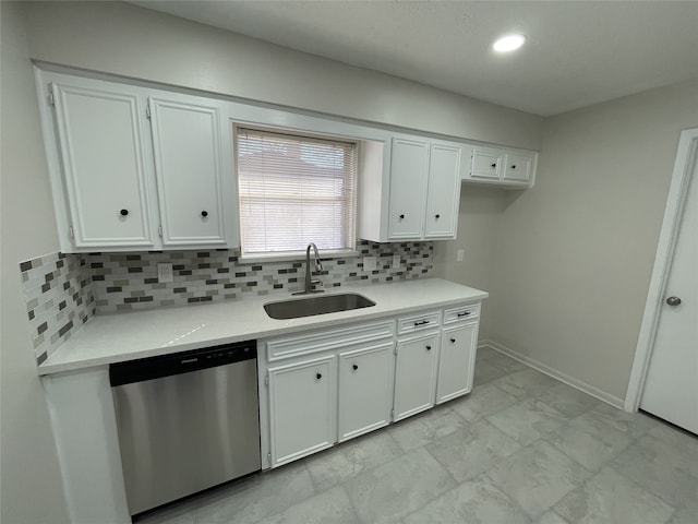 kitchen featuring sink, white cabinetry, backsplash, light stone counters, and stainless steel dishwasher