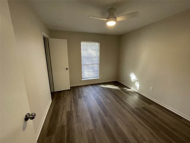 empty room featuring ceiling fan and dark hardwood / wood-style flooring