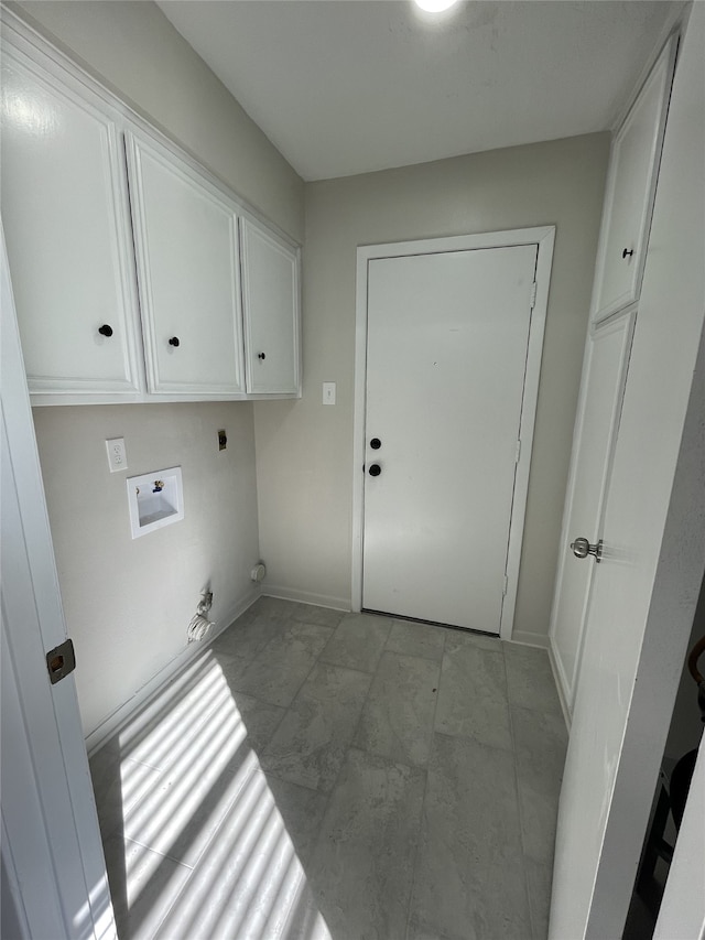 clothes washing area with hookup for a washing machine, gas dryer hookup, hookup for an electric dryer, and cabinets