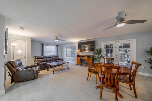 dining area featuring light hardwood / wood-style flooring, french doors, and ceiling fan