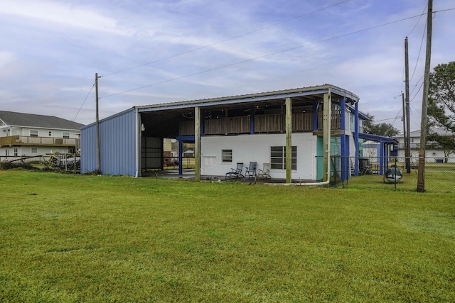 back of property featuring an outbuilding and a lawn