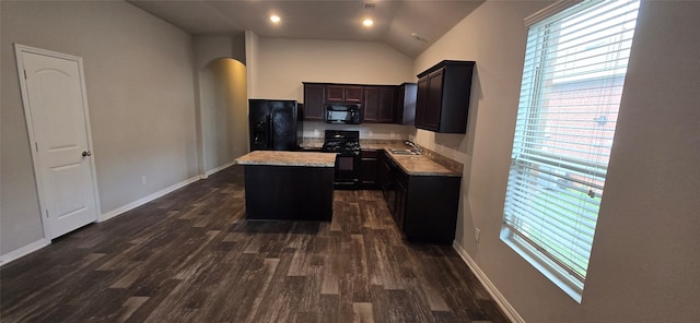 kitchen with lofted ceiling, sink, a center island, black appliances, and dark wood-type flooring