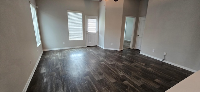 unfurnished room featuring ceiling fan and dark hardwood / wood-style flooring