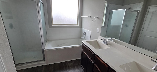 bathroom featuring shower with separate bathtub, wood-type flooring, and vanity