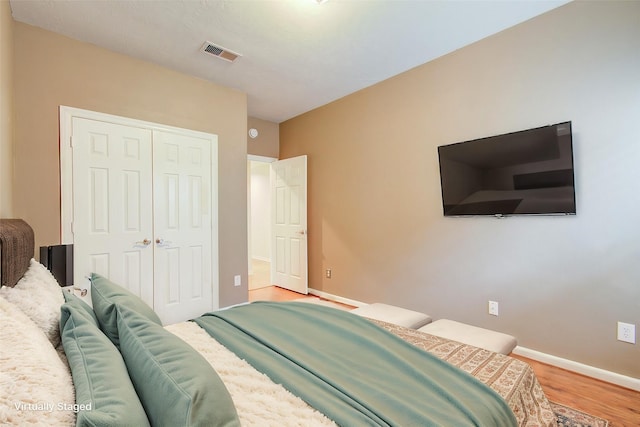 bedroom featuring a closet and light wood-type flooring