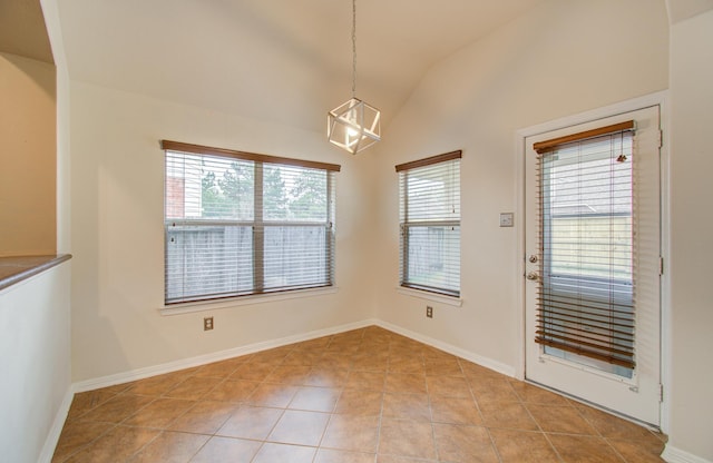 unfurnished dining area featuring vaulted ceiling and light tile patterned flooring