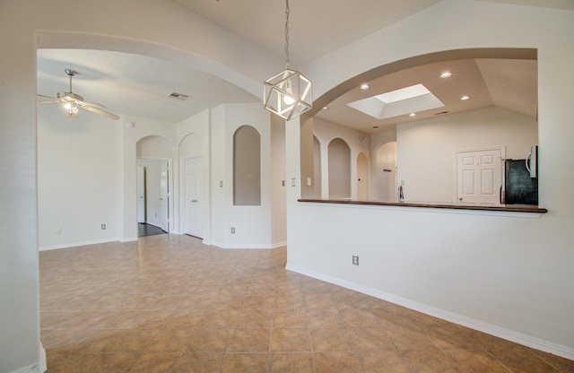 empty room with lofted ceiling and ceiling fan