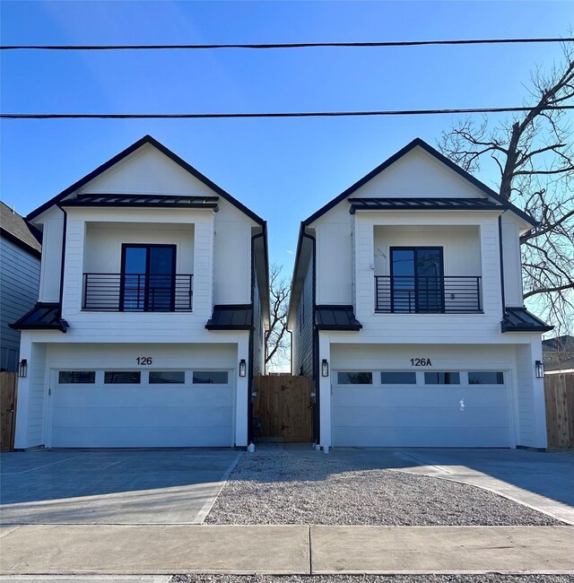 view of front facade featuring a garage and a balcony