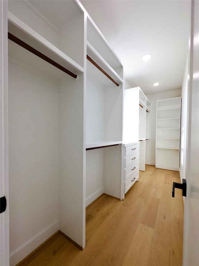 spacious closet featuring light hardwood / wood-style floors