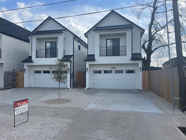 view of front of property featuring a balcony and a garage