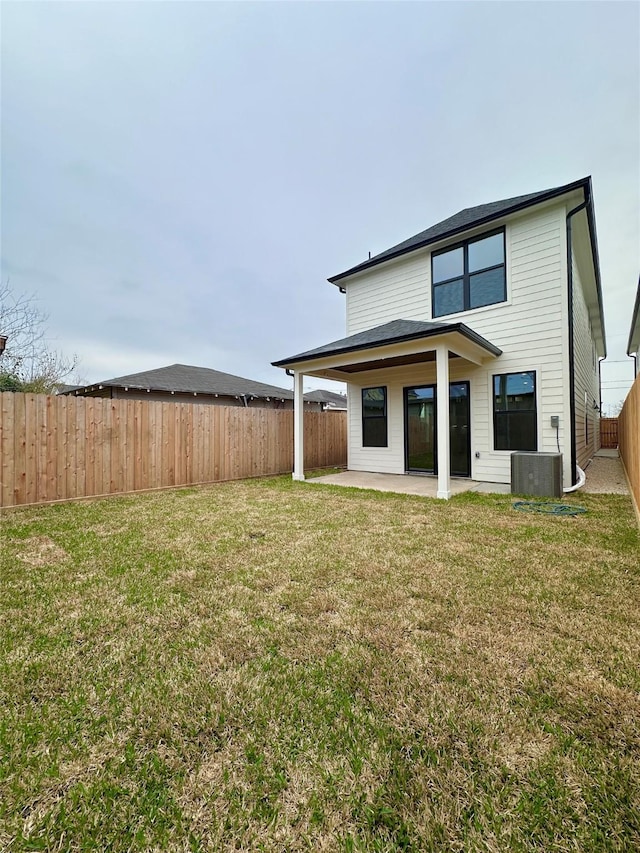 rear view of house featuring a patio and a lawn