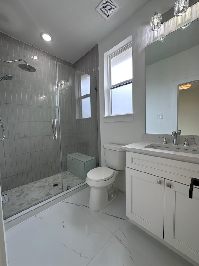 bathroom with vanity, an enclosed shower, and toilet