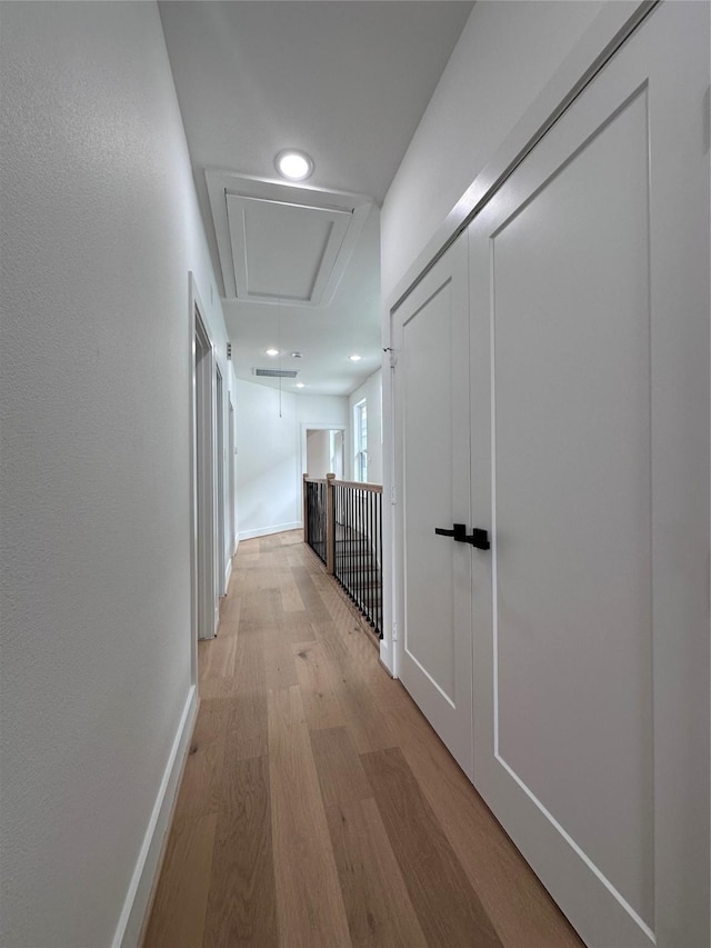 corridor with light hardwood / wood-style flooring