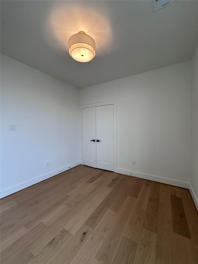 empty room with light hardwood / wood-style flooring