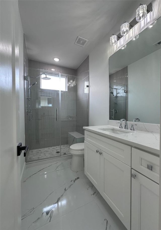 bathroom featuring vanity, an enclosed shower, and toilet