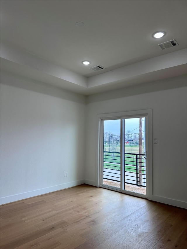 unfurnished room with light hardwood / wood-style floors