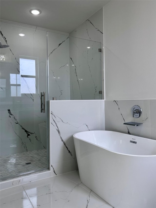 bathroom with shower with separate bathtub