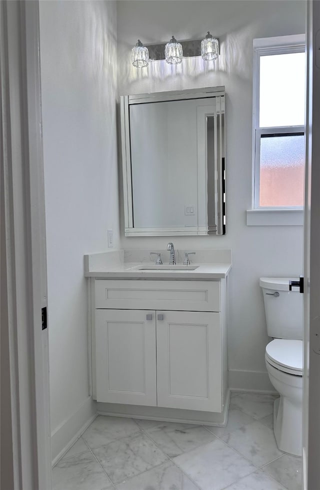 bathroom featuring vanity and toilet