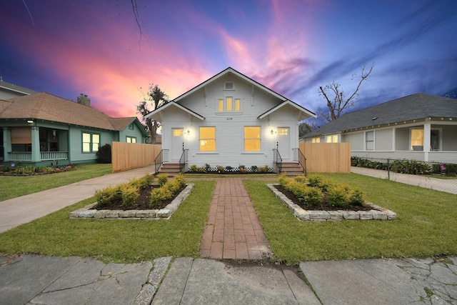 bungalow featuring a lawn