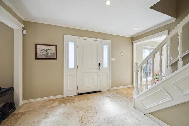 foyer entrance featuring crown molding