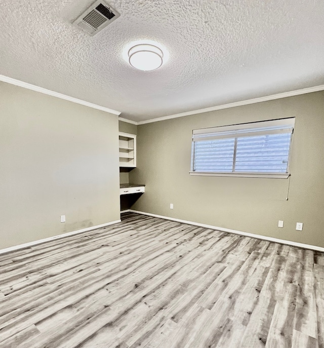 unfurnished bedroom with crown molding, light hardwood / wood-style floors, and a textured ceiling