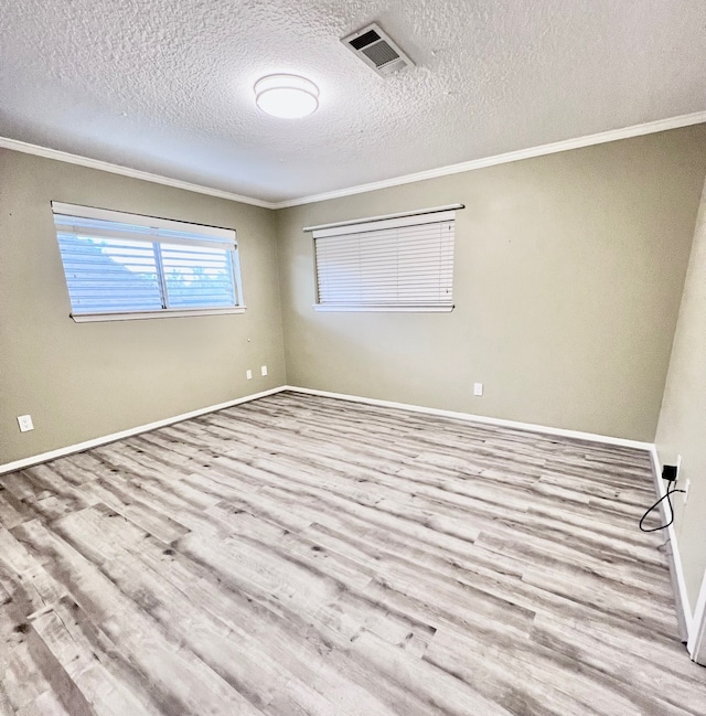 unfurnished room with crown molding, a textured ceiling, and light hardwood / wood-style flooring